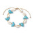 Cowrie Shell and Aqua Howlite Dolphin adjustable bracelet on a white background