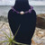 Amethyst Crystal Chip and Freshwater Pearl Stainless Steel Anklet on black stand with air plant, rock and ocean behind