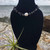 Black Obsidian Crystal Chip and Freshwater Pearl Stainless Steel Anklet on black stand with air plant, rock and ocean behind