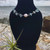 Aquamarine Crystal Chip and Freshwater Pearl Stainless Steel Anklet on black stand with air plant, rock and ocean behind