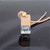 Glass pendant with wood lid and cord on grey background