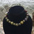 Dragon's Blood Jasper 6mm & 8mm bead bracelet resting on black velvet display with rock face behind