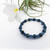 Blue Kyanite 6mm & 8mm Bead Bracelet - with Frangipani flower and Air Plant - on a white background