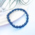 Hematite 8&10mm Bead Bracelet resting on a shell with a white background