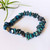 Chrysocolla Chip Bracelet on white background with air plant behind