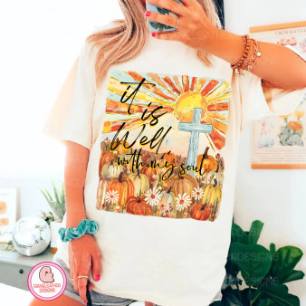 Vibrant sun, blue cross, pumpkins, and daisies with “It is well with my soul” in bold script Vibrant sun, blue cross, pumpkins, and daisies with “It is well with my soul” in bold script