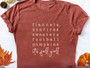 orange long sleeve shirt with writing
