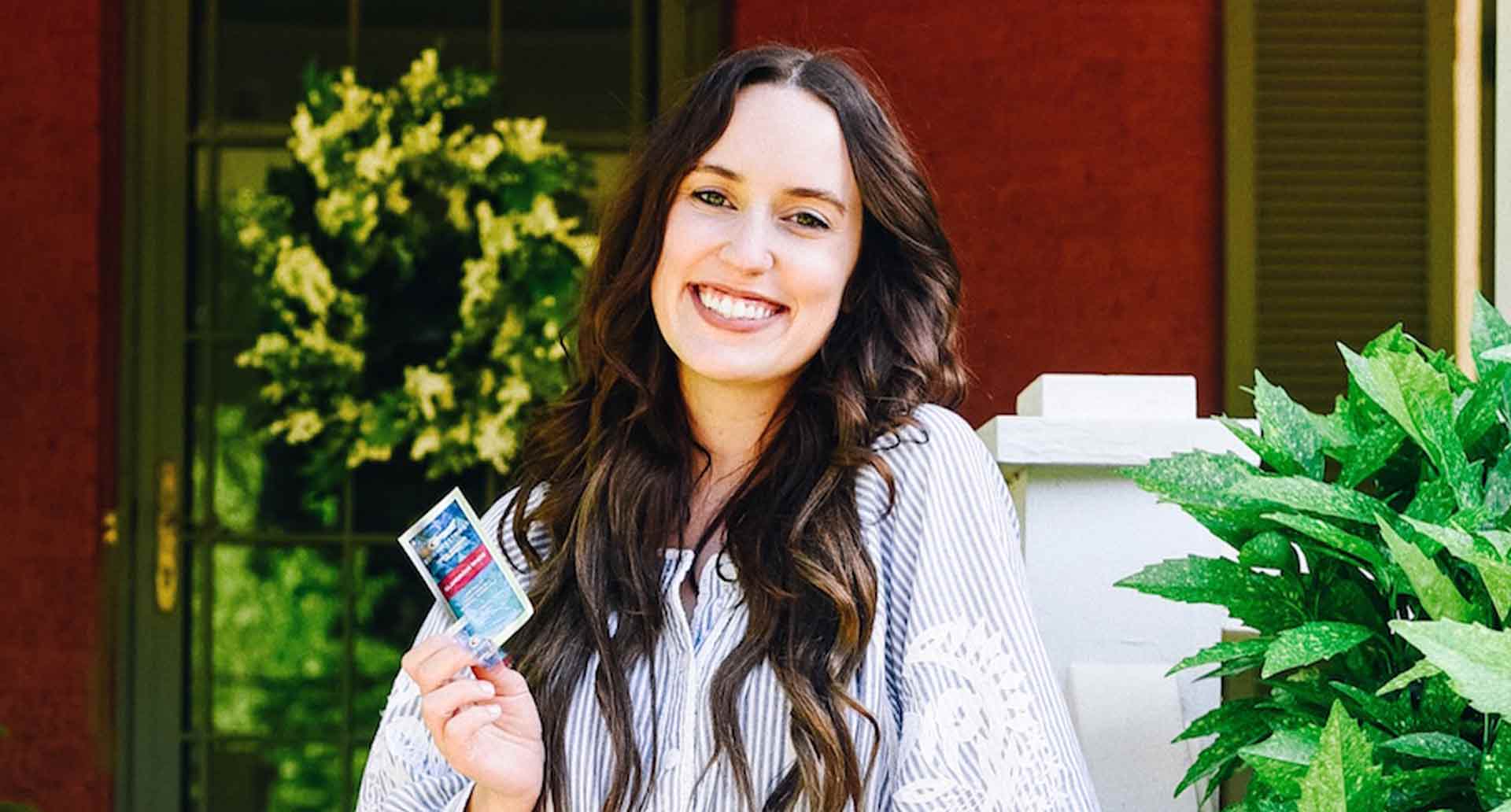 Brunette holding Crest 3DWhitestrips Kits