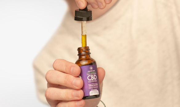 Man holding CBD oil tincture