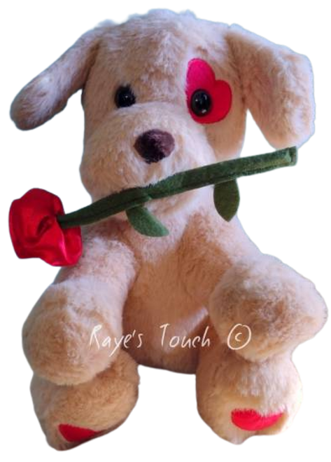 10" Plush Puppy Dog sitting w/ a Red Rose in his or her mouth & a red heart over one eye and both paws.