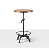 Whiskey bar table in a small tavern, with a rotating circular wooden top and metal base that can be easily adjusted by a crank