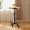 Whiskey bar table in a small tavern, with a rotating circular wooden top and metal base that can be easily adjusted by a crank