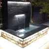 Landscape fish pond flowing water wall waterfall outlet. Stainless steel outlet trough rockery and flowing water waterfall