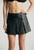 Front view of soft leather skirt with stylish open panel design and fitted waist