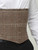 Close-up of the front steel busk and waist-trimming band detail on the male corset.