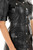 Black leather dress close-up – snap button pocket detail and stitching