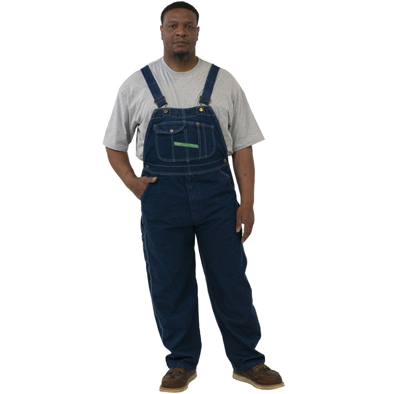 Portrait of female farmer in front of the farmhouse shed. Woman dressed in  plid shirt and denim jeans overalls as farm worker with hands on hips Stock  Photo - Alamy