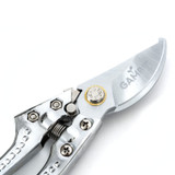 Close-up of Gambit Growing bypass pruning shears featuring a precision-ground stainless steel blade with engraved branding, adjustable tension pivot, and heavy-duty spring mechanism designed for clean, controlled plant trimming.