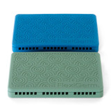FlexiGerm seed starter trays in blue and green shown from above, featuring textured lids designed to regulate airflow and moisture during seed germination