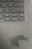 Refurbished The keyboard of a laptop showing a spill stain on the lower left corner, indicating an accidental liquid exposure to
