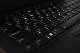 Refurbished A close-up view of a laptop keyboard, showing illuminated keys, including the Shift key on the right side.