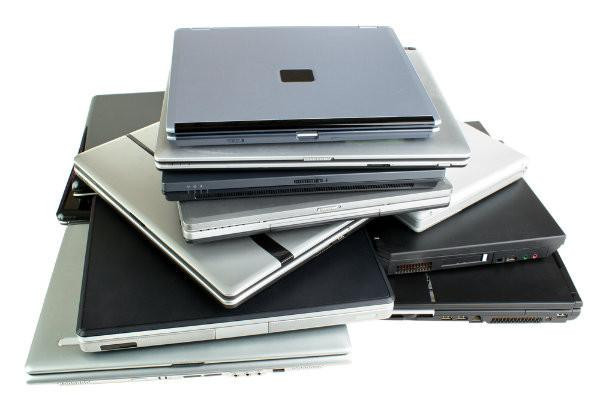 Refurbished Used laptop pile: Multiple models, no specific brand or feature highlighted.