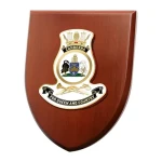 HMAS Canberra Shield Plaque An Exceptional HMAS Canberra Plaque order now. This beautiful plaque features a 100mm full colour enamel crest set on a 200x160mm timber finish shield. Presented in a stylish silver gift box with form Image 1 