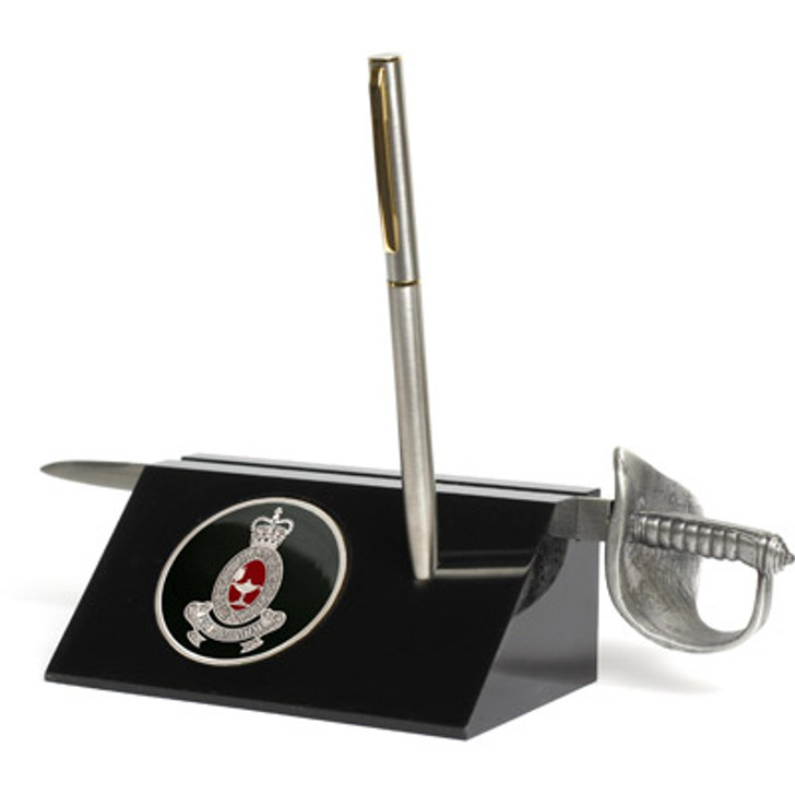 RAANC Sword Desk Set RAANC Sword Desk Set Royal Australian Army Nursing Corps (RAANC) Medallion in a stylish acrylic desk stand with a quality pen and Army sword letter opener.  Presented in a silver gift box with a clear lid, this is the per