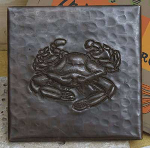 Crab design on hammered copper tile Crab design on hammered copper tile