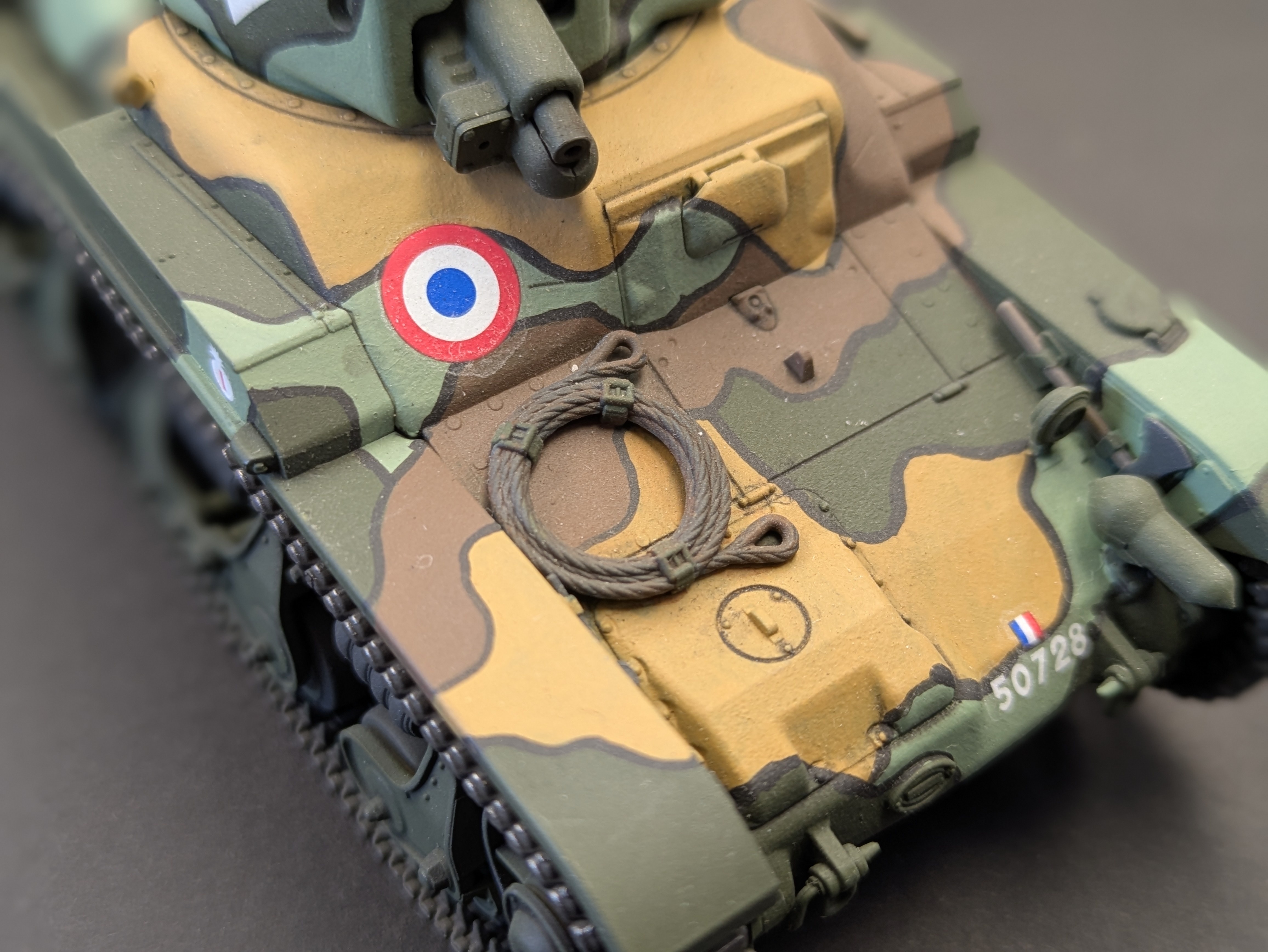 Close-up of front of tank showing decals and tow cable