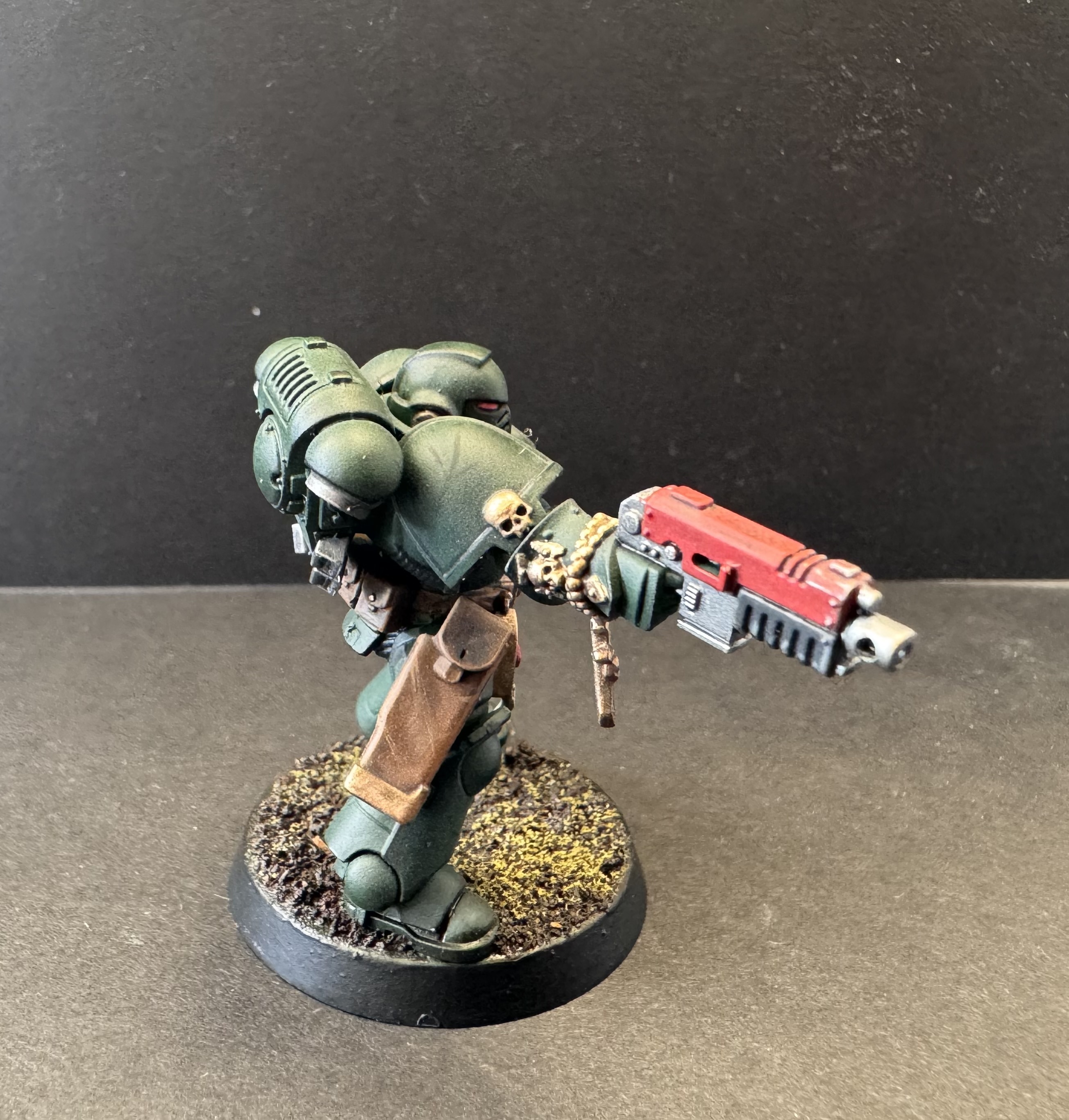 Right side profile showing utility belt bags and right hand weapon