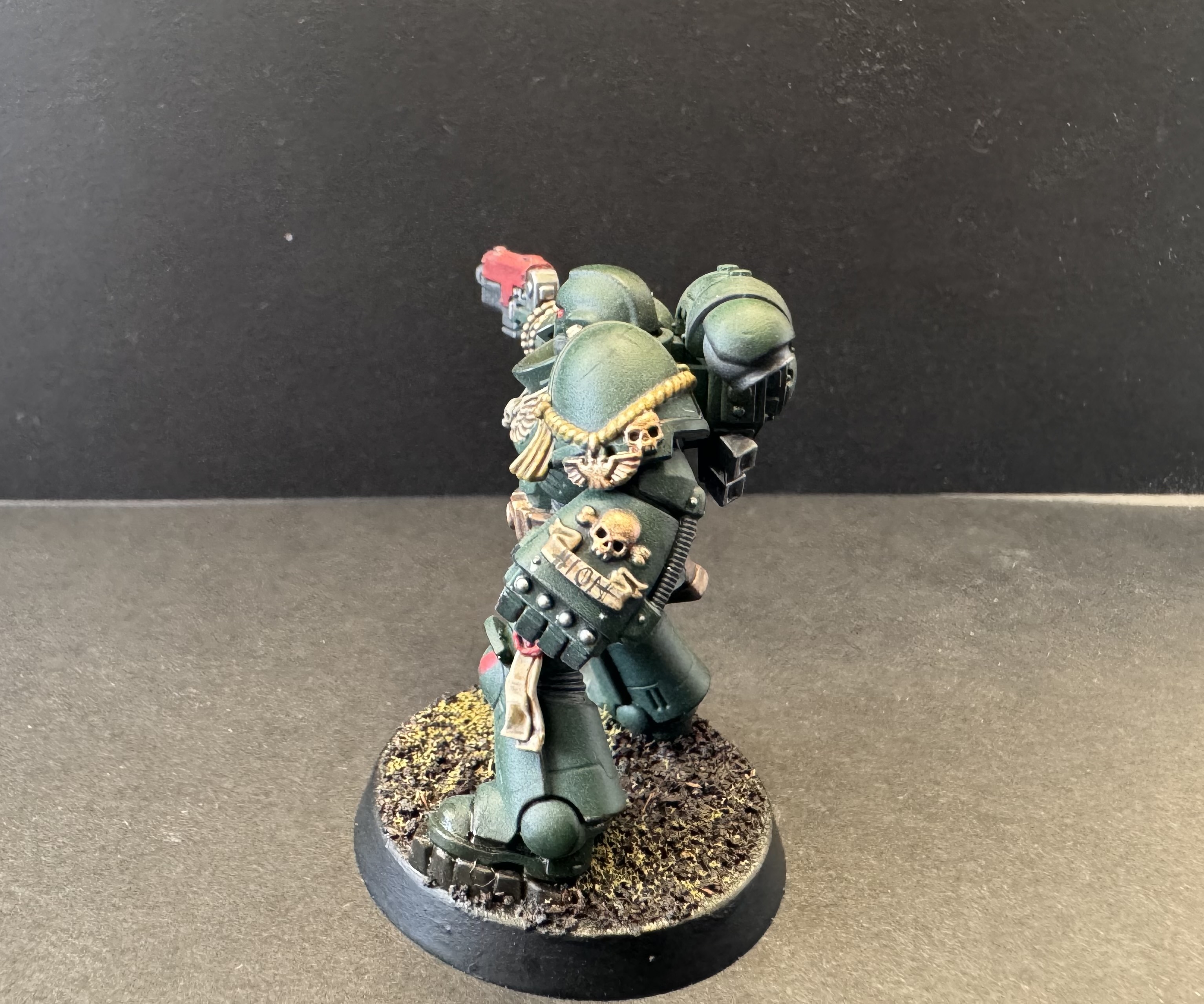 Left side profile showing power fist and lion freehand on parchment