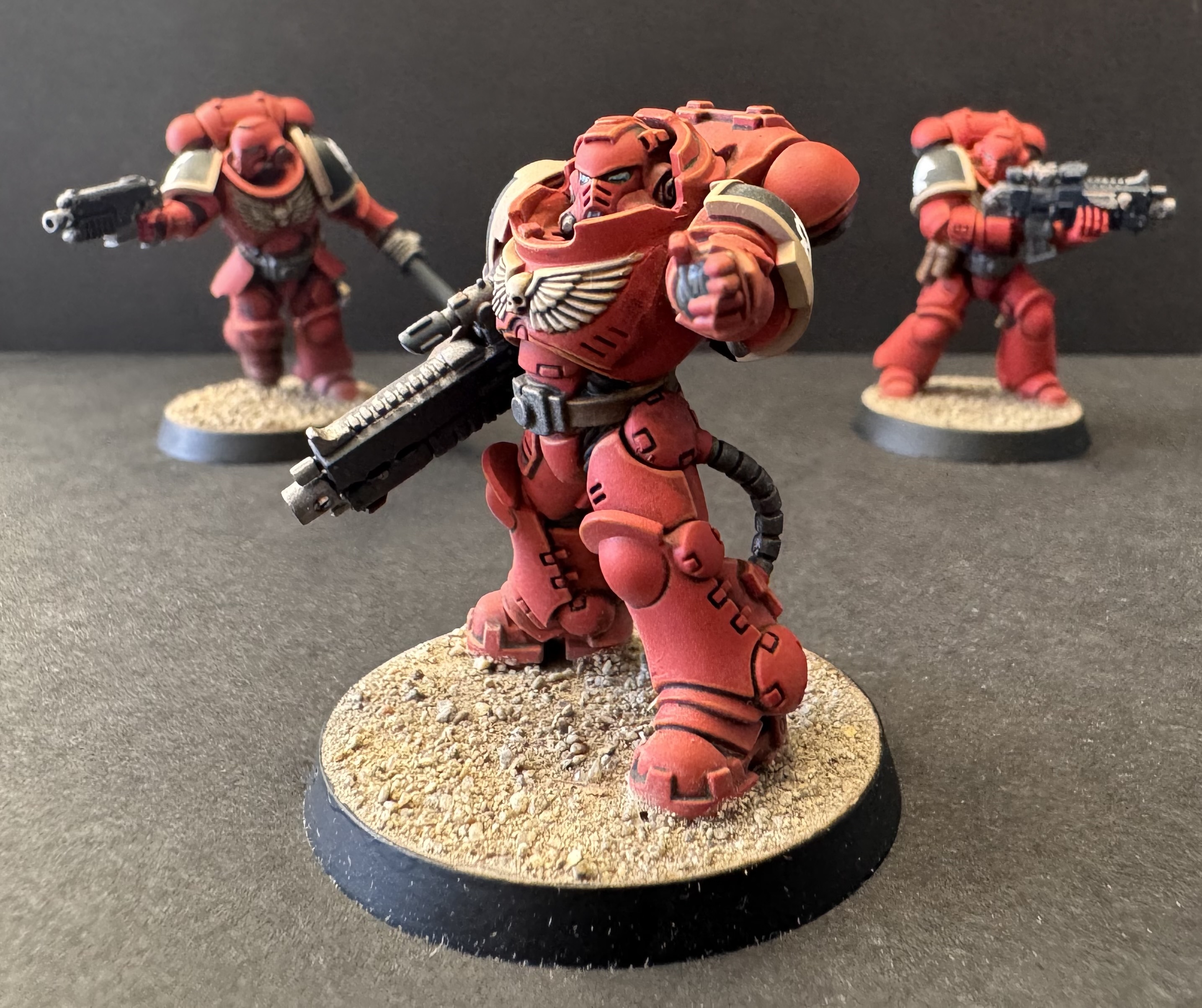 Heavy Intercessor pointing at camera with squad out of focus behind - hero image