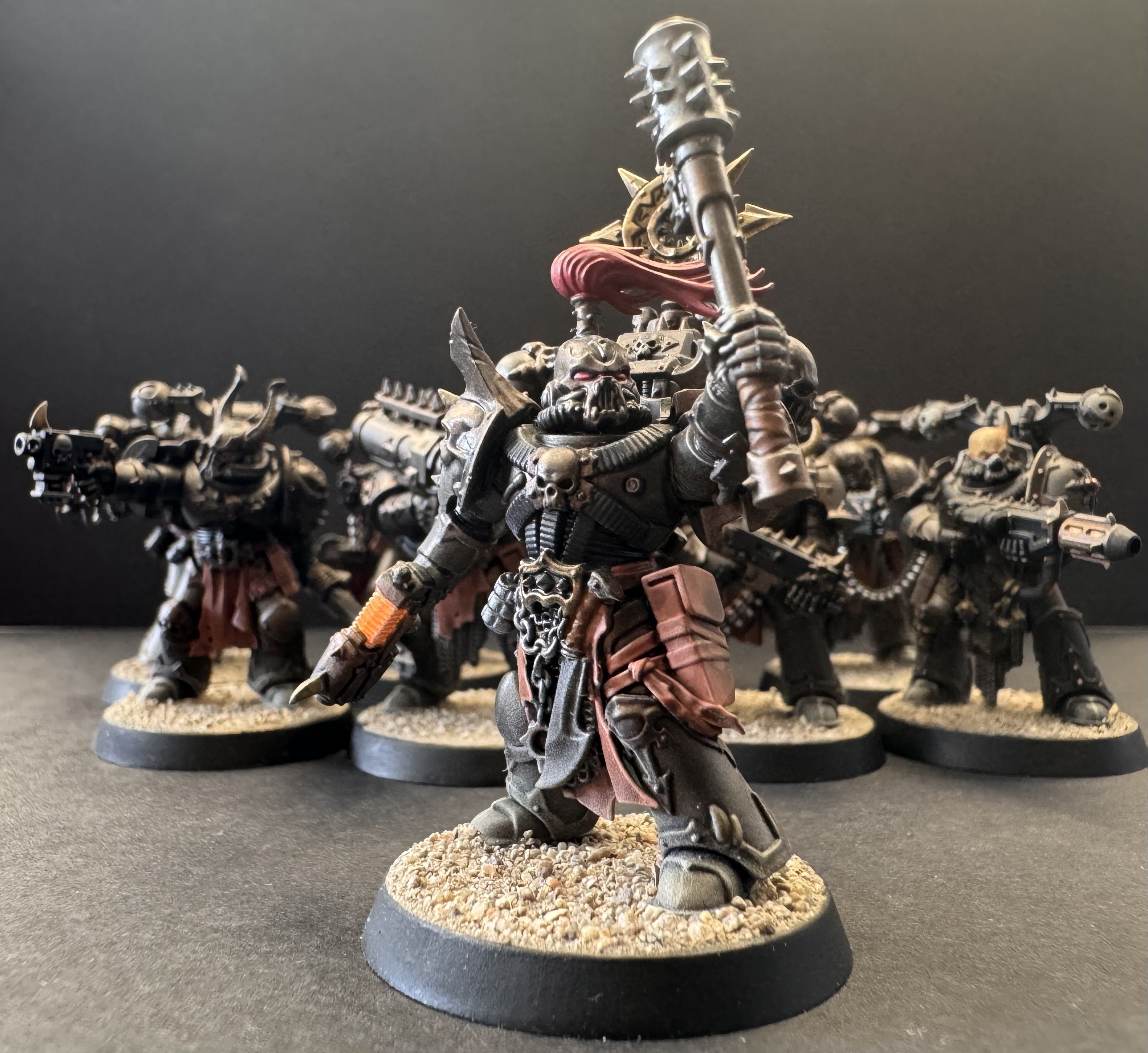 Chaos Marines captain hero shot with squad in background showing orange plasma glow