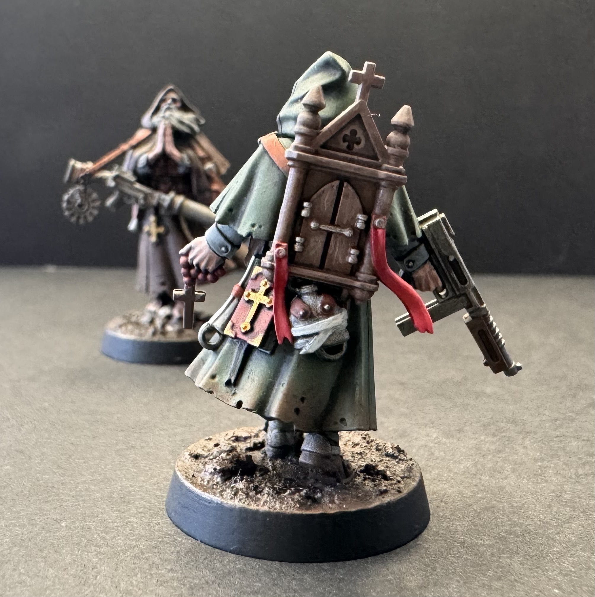 Green robe - back pose showing wooden cathedral backpack and book