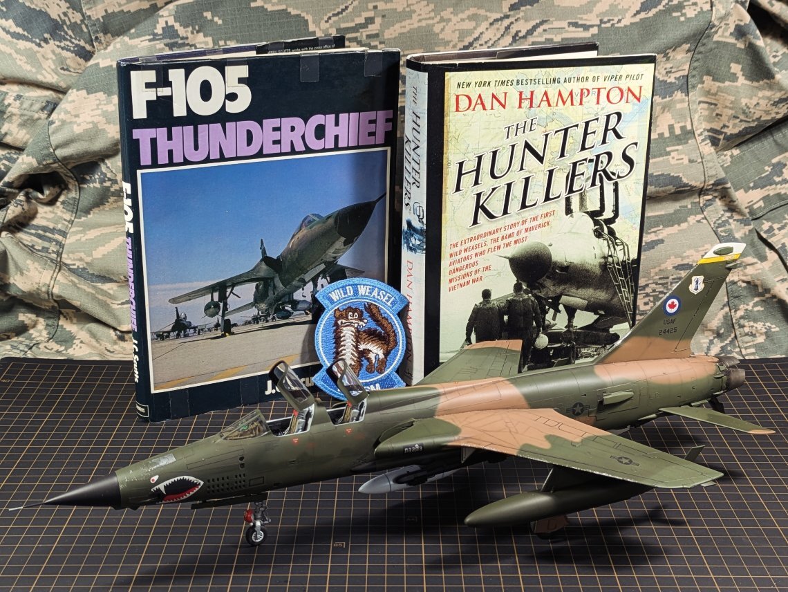 F-105G three-quarter front with reference books and Wild Weasel badge
