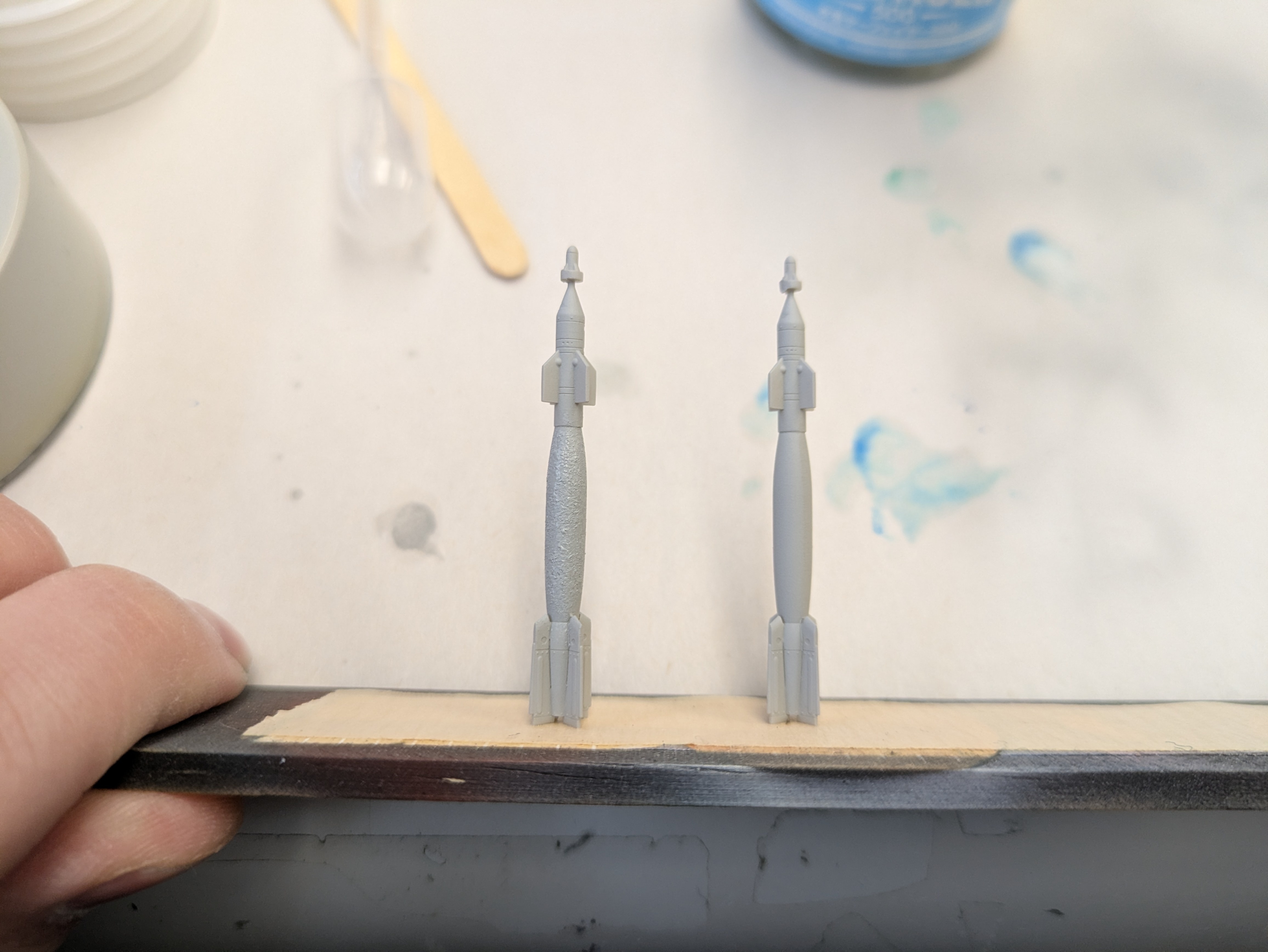 Two bomb bodies side by side: left stippled thermal coating, right smooth for comparison