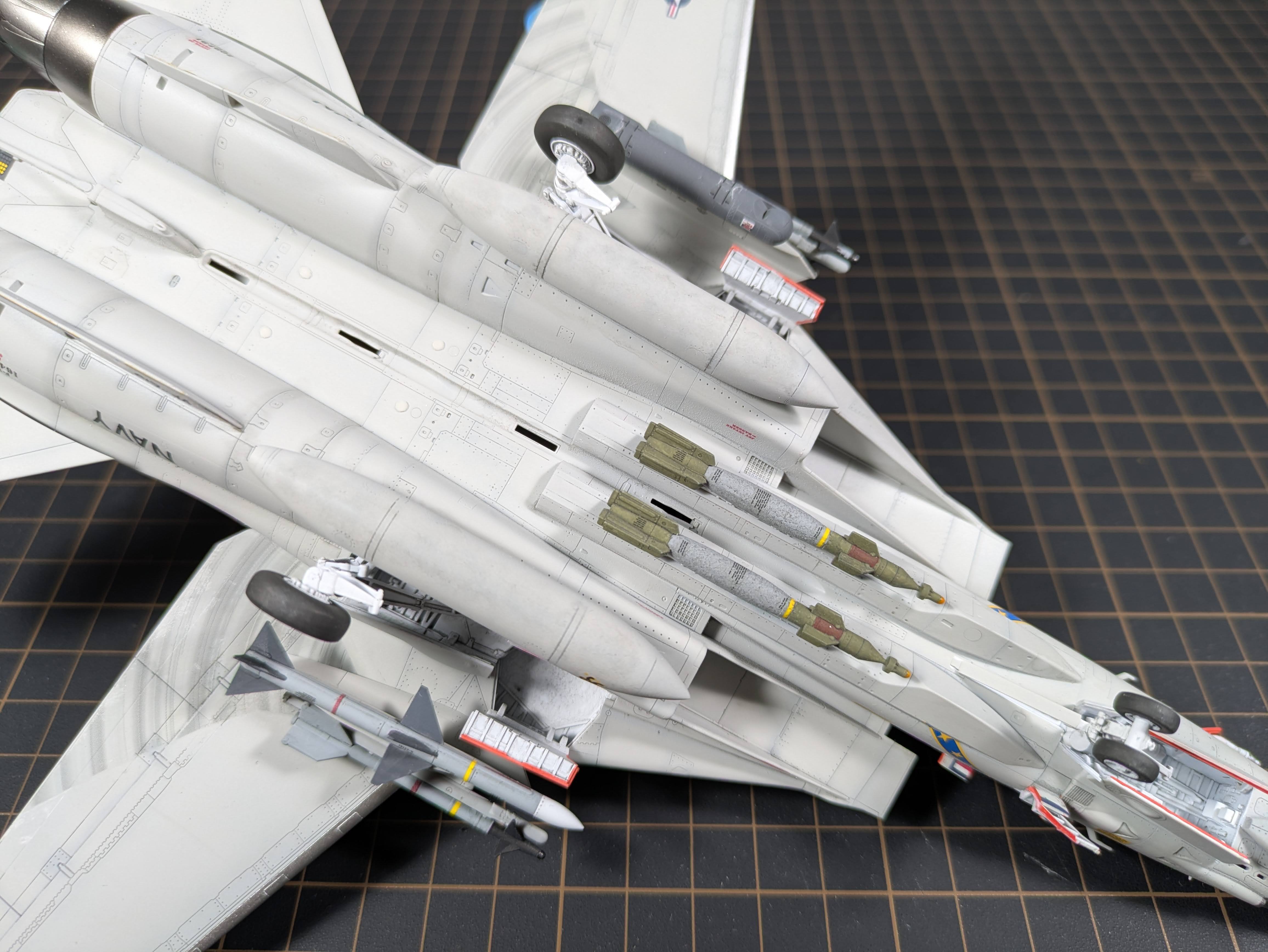 Belly closeup showing ordnance load &mdash; GBUs and Phoenix missiles