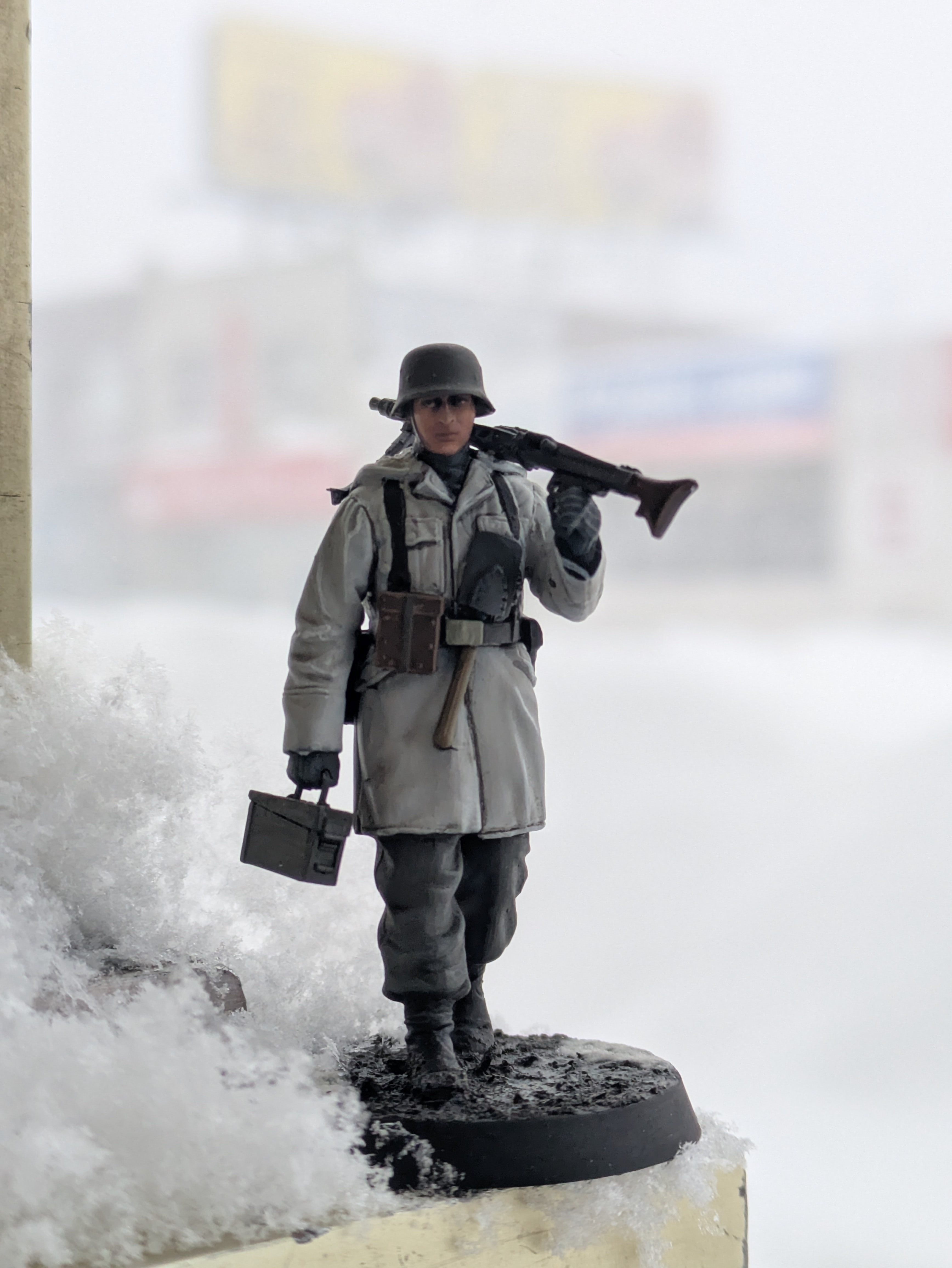 1/35 StuG III crewman figure in winter scheme photographed against a real snowstorm