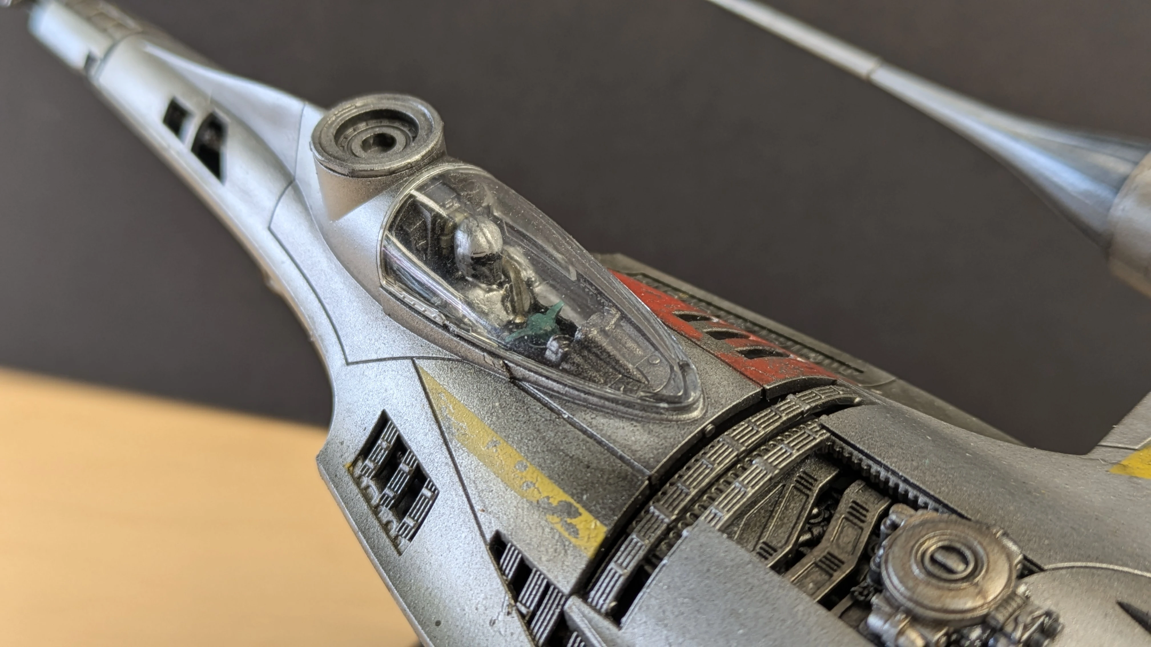N-1 Starfighter cockpit close-up with Mandalorian figure and Grogu painted in Citadel Warpstone Glow