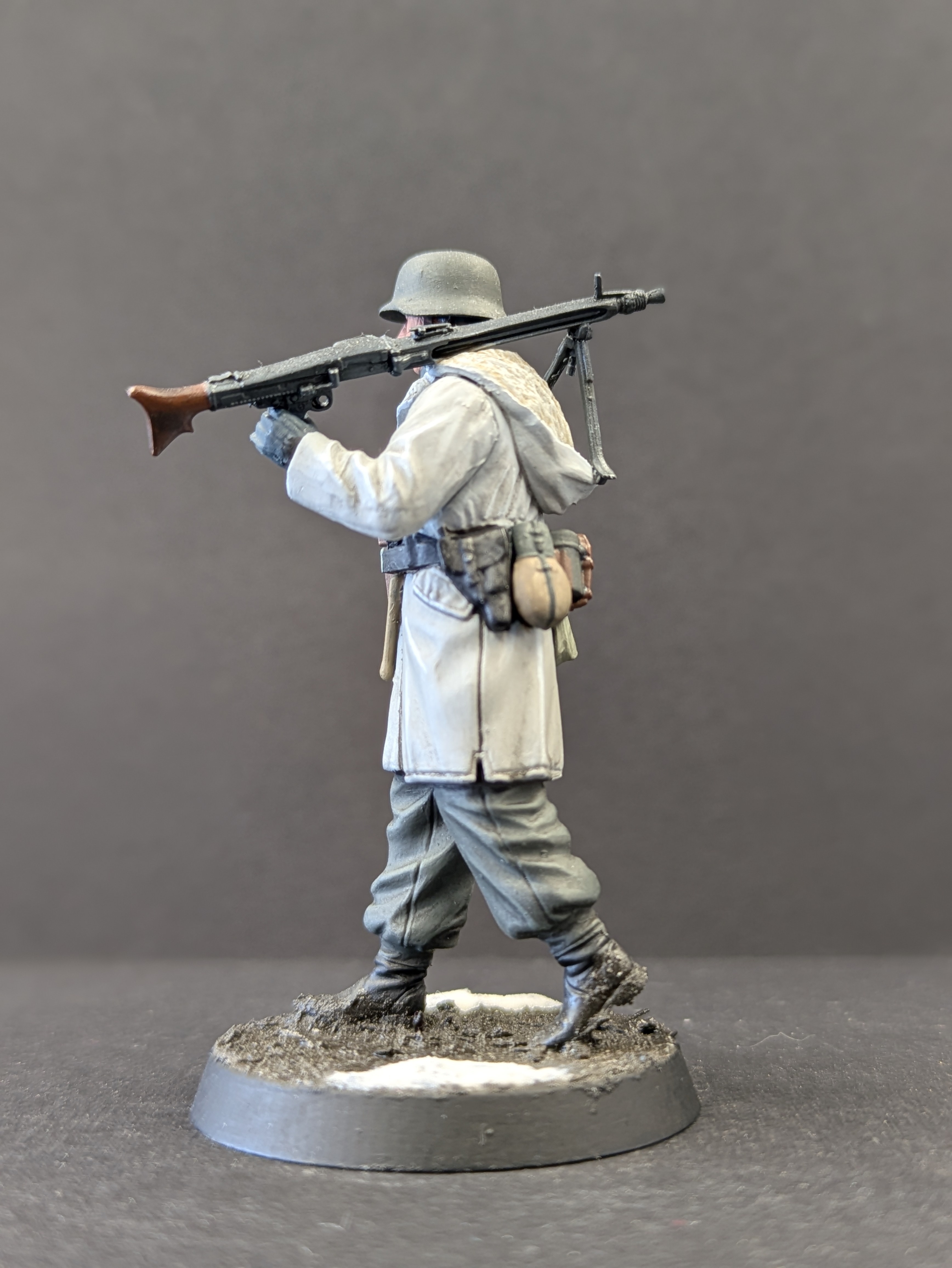 Side profile - gun forward, pistol holster and packs visible