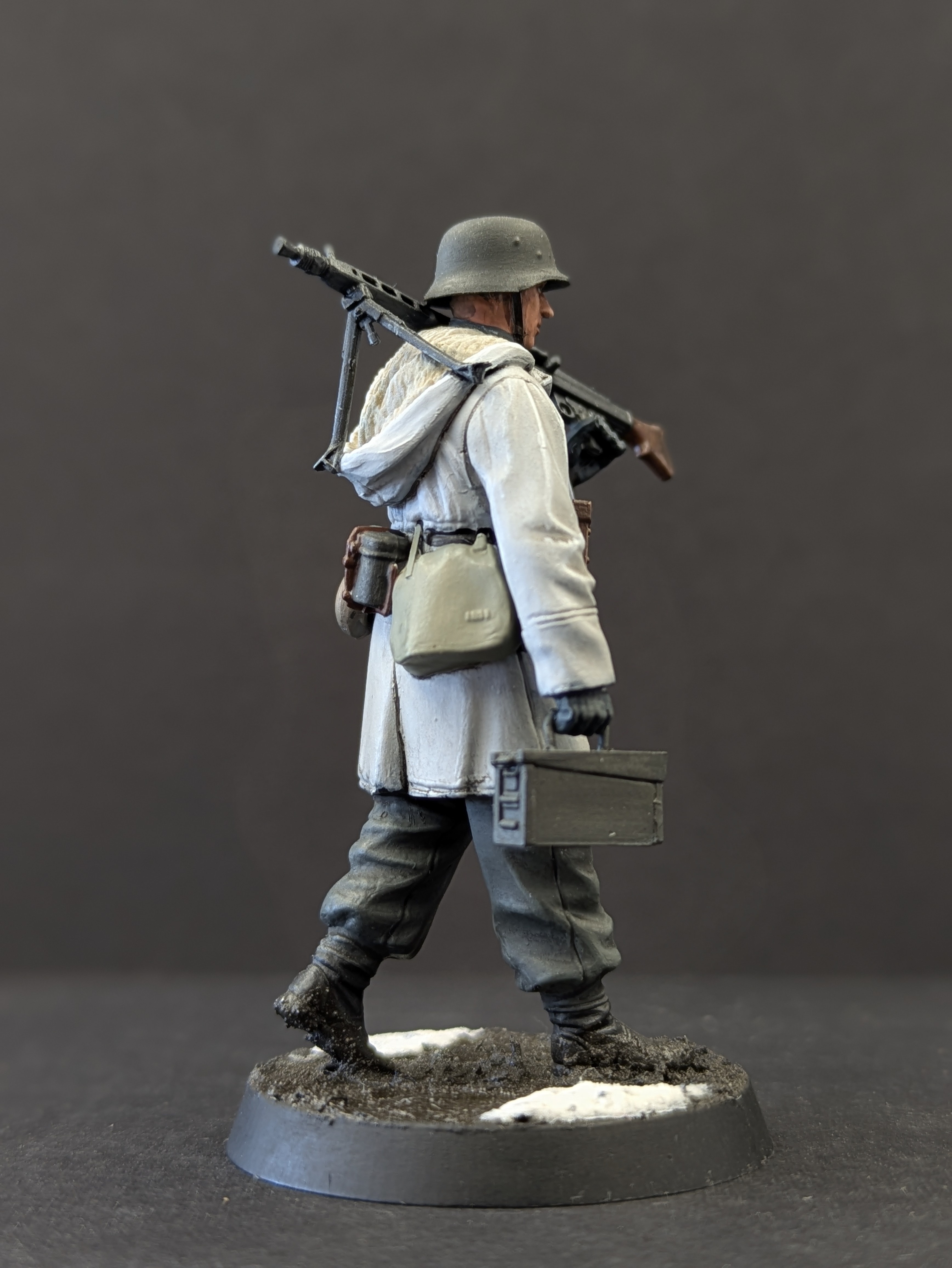 Three-quarter rear pose showing coat and ammo crate