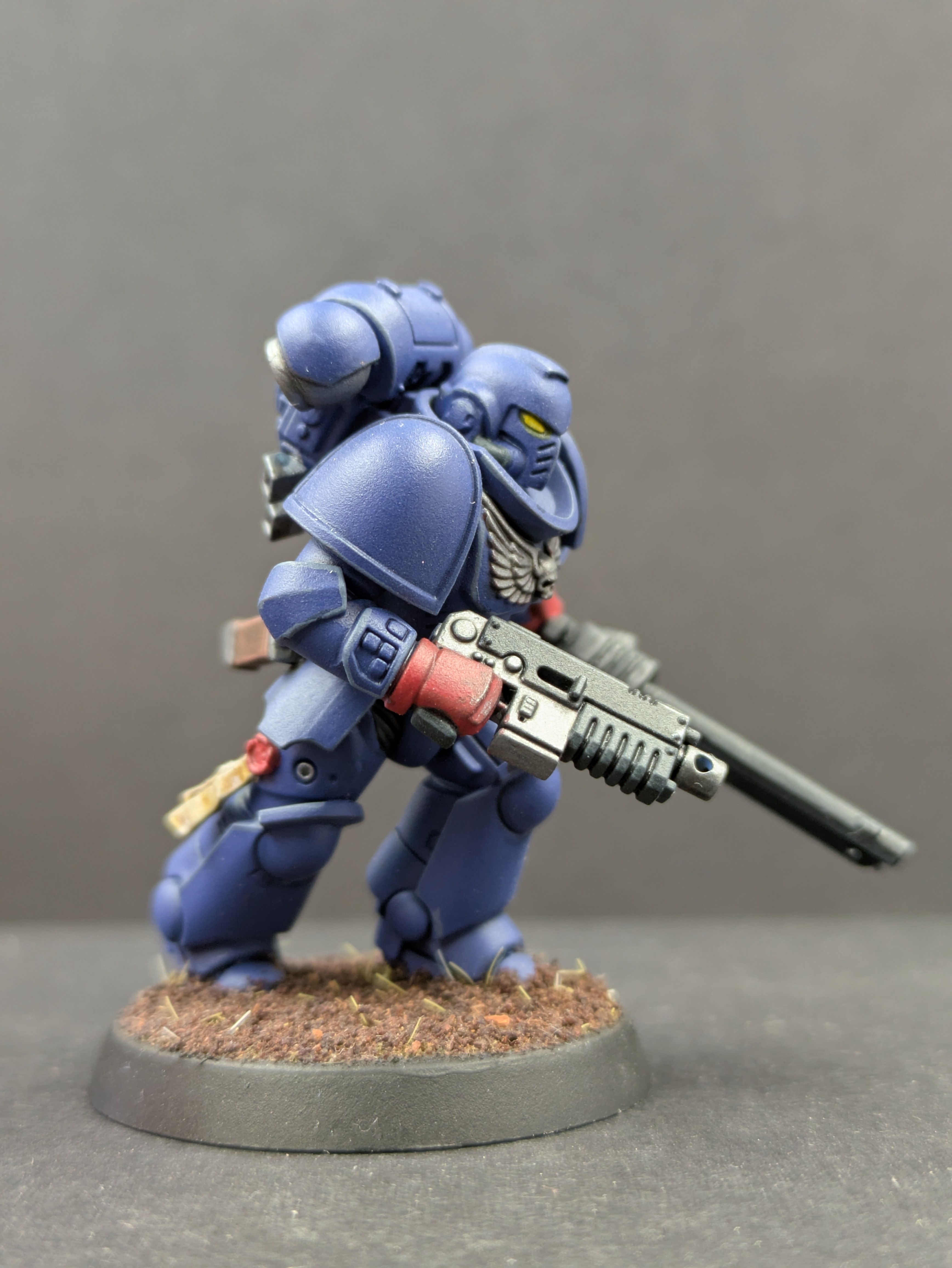 Side/front movement view - helmet, eyes, and bolter