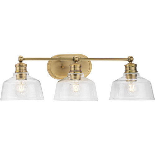 Singleton Collection Three-Light 26.5" Vintage Brass Farmhouse Vanity Light with Clear Glass Shades (P300397-163)