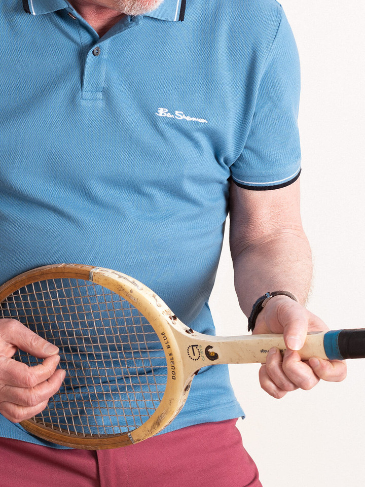 Close Up Image of Blue Ben Sherman Polo Shirt and Tennis Racket