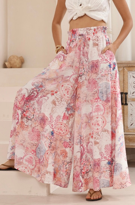 Bring effortless island vibes to your wardrobe with our Reidun Wide Leg Pants. Featuring an elasticised waist and functional pockets, these lightweight flowy pants offer a flattering, easy fit that moves beautifully with you. Pair with a white crop or tank for a chic resort look, perfect for sunny days and relaxed afternoons.

These pants feature:

Elasticised waist with functional drawstring
2 side pockets
Full length, wide leg fit
Pink Floral print
Lightweight
Unlined
Colour: Pink Floral

Fabric: 84% Rayon, 14% Viscose

Size Guide: True to size. Model is 178cm and is wearing a size 8.