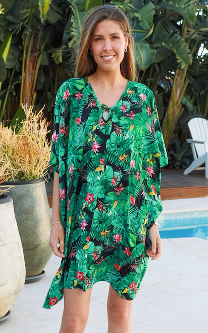 Immerse yourself in the lush beauty of our Jungle Bloom Kaftan. This vibrant piece features a captivating print of rich green foliage, interspersed with delicate pink and yellow tropical flowers, all set against a sophisticated dark background. Designed with a flattering V-neckline with tie details and a relaxed, flowing silhouette, this kaftan offers both comfort and effortless style. Perfect for poolside glamour, a chic beach cover-up or a relaxed yet elegant summer dress. Step into a world of tropical charm and make a vibrant statement wherever you go.

Colour: Green

Fabric: 100% Rayon

Size: OSFA