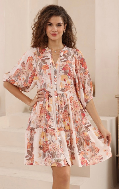 Model wearing orange and pink floral Annabelle babydoll mini dress with button front, pockets and flowy sleeves