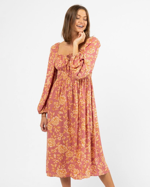 This chic, feminine, transeasonal style is one you're sure to adore! Pair with brown or tan boots on cooler days or sandals during the warmer months.

This dress features:

Elasticated neckline with tie up front
Shirred bodice
Long sleeves with elastic cuffs
Not lined
Colour: Blush with orange floral print

Fabric: 100% Rayon
Suburban Closet