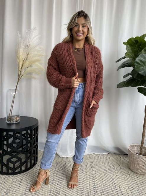 This cardi features:

Super soft and fluffy 
2 Front pockets
Ribbed cuffs and hemline
Front plait detail 
Relaxed oversized fit
Mid-weight knit with stretch
Colour: Chocolate

Fabric: 65% Acrylic; 35% Wool

Size: S/M will fit sizes 8-12; M/L will fit sizes 14-16.
Suburban Closet